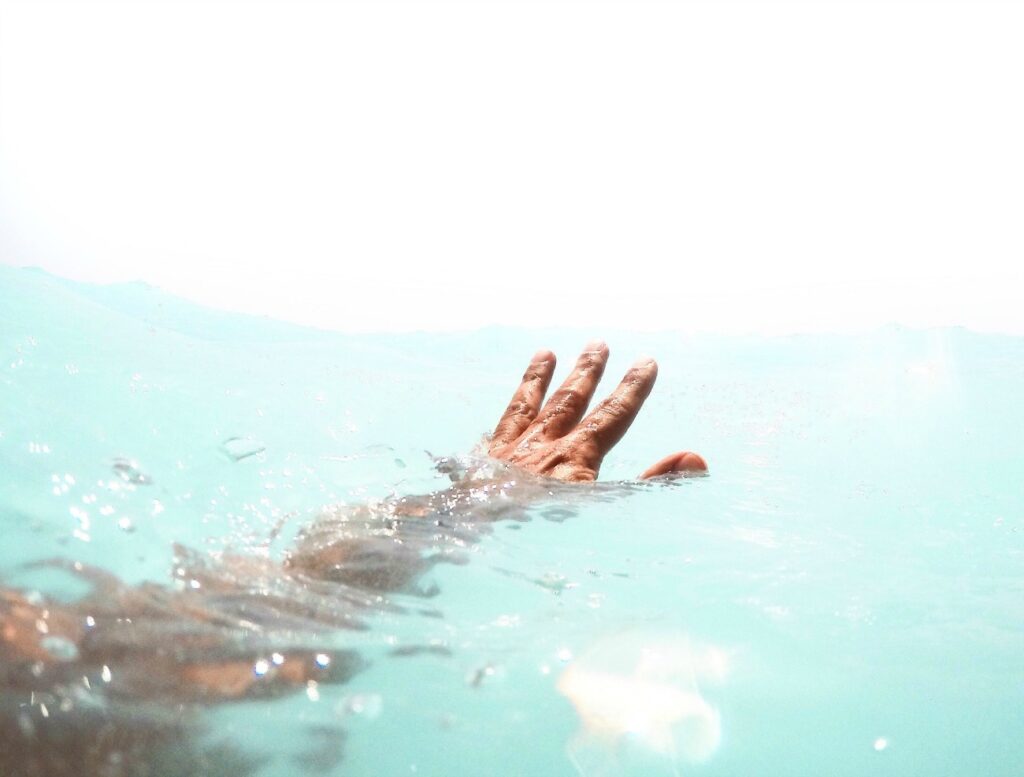 Hand of an African American female in the water.