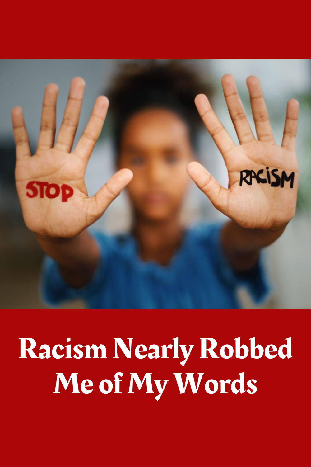 A young girl holding up her hands with stop racism painted on her palms.
